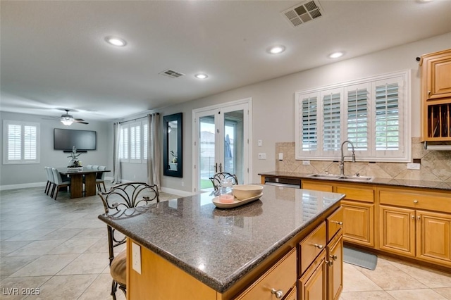 kitchen with backsplash, a sink, and visible vents