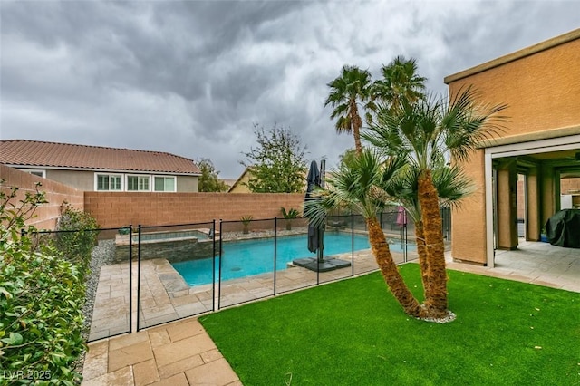 view of pool featuring a lawn, a patio, a fenced backyard, a grill, and a pool with connected hot tub