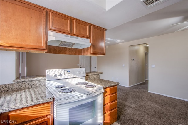 kitchen with carpet, white electric stove, visible vents, brown cabinetry, and under cabinet range hood