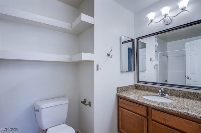 bathroom with a shower, vanity, and toilet