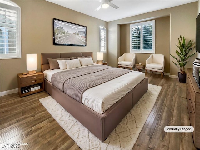 bedroom with ceiling fan, baseboards, and wood finished floors