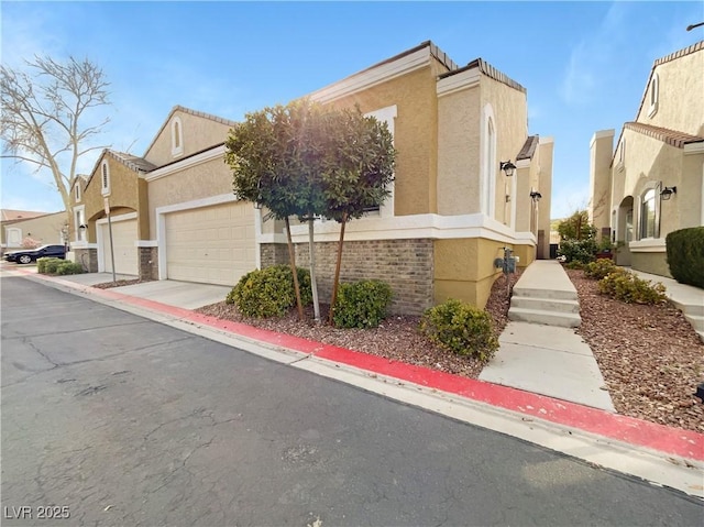 view of home's exterior with a residential view, stucco siding, concrete driveway, and a garage