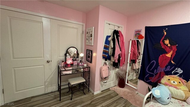 interior space featuring baseboards and wood finished floors