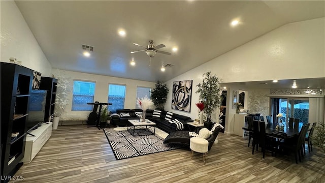 living area with a ceiling fan, visible vents, and wood finished floors