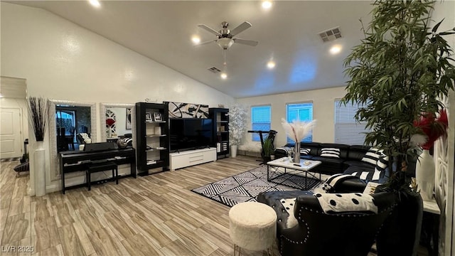 living area featuring high vaulted ceiling, visible vents, ceiling fan, and wood finished floors