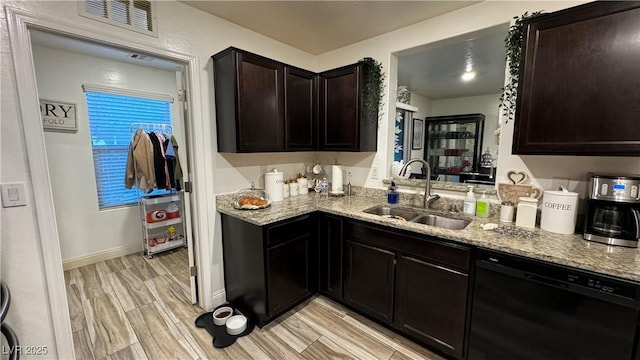 kitchen featuring light stone counters, a sink, visible vents, black dishwasher, and wood tiled floor