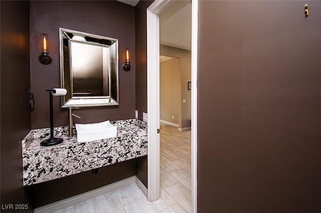 bathroom featuring baseboards and vanity