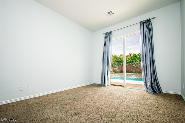 carpeted empty room featuring baseboards, visible vents, and vaulted ceiling