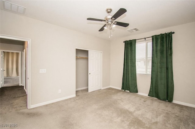 unfurnished bedroom featuring carpet floors, a closet, visible vents, and baseboards