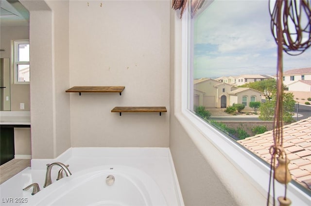 bathroom featuring a residential view and a bathing tub