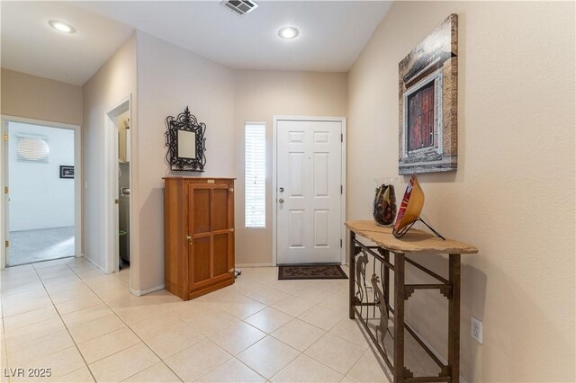 foyer with light tile patterned flooring, recessed lighting, visible vents, and baseboards