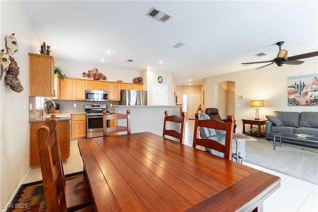 dining space featuring recessed lighting, visible vents, arched walkways, and ceiling fan