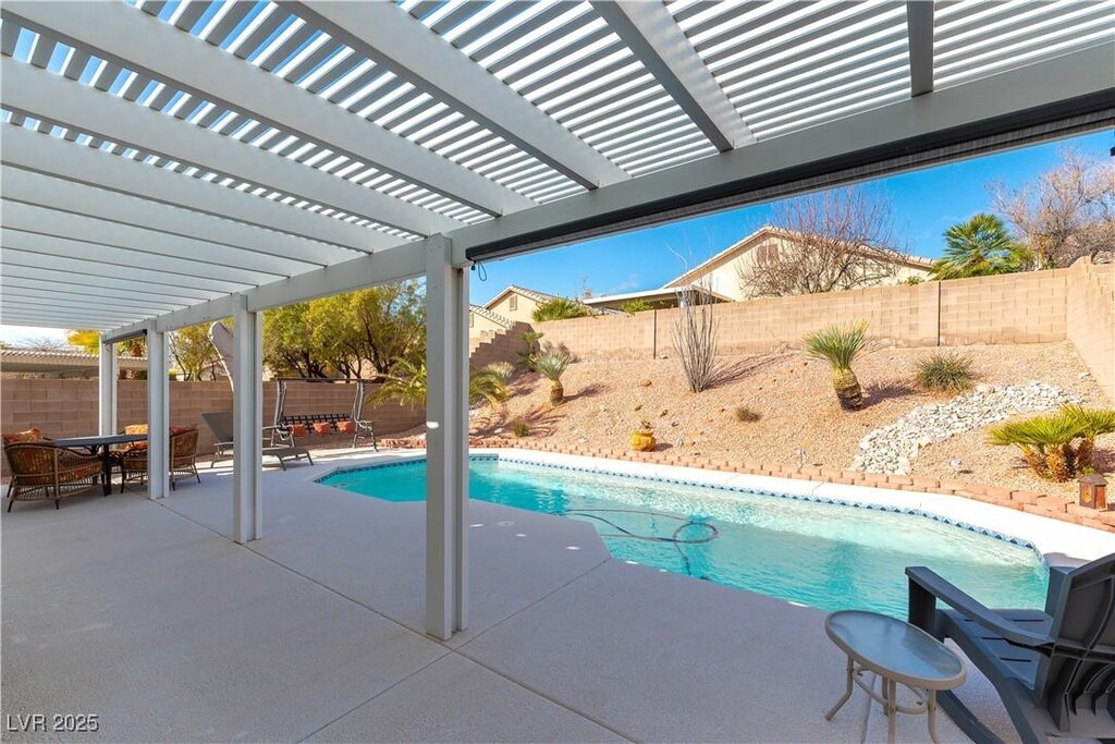 view of swimming pool featuring outdoor dining area, a pergola, a patio, a fenced backyard, and a fenced in pool