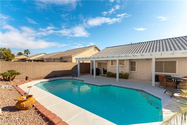 view of swimming pool featuring a patio, fence, and a fenced in pool