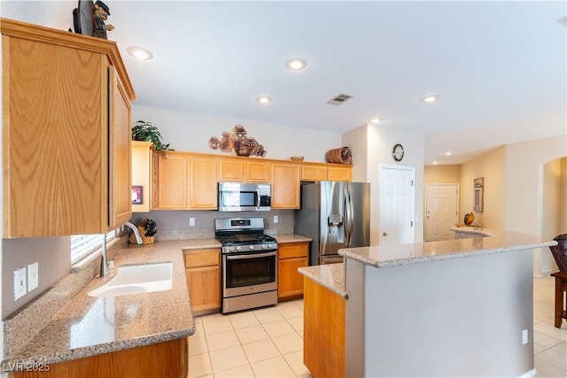 kitchen with visible vents, a center island, recessed lighting, appliances with stainless steel finishes, and a sink