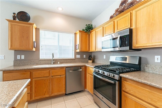 kitchen featuring light tile patterned floors, recessed lighting, a sink, light countertops, and appliances with stainless steel finishes