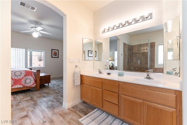 bathroom with a sink, visible vents, ensuite bathroom, and a shower stall