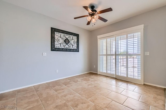 spare room with light tile patterned floors, baseboards, and ceiling fan