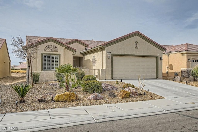 mediterranean / spanish-style house with a tile roof, an attached garage, driveway, and stucco siding