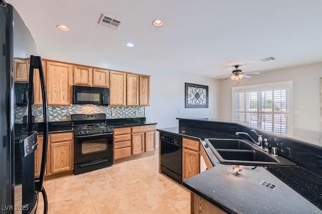 kitchen featuring a sink, visible vents, tasteful backsplash, and black appliances