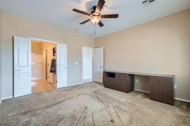 unfurnished bedroom with visible vents, baseboards, light carpet, ensuite bath, and a ceiling fan