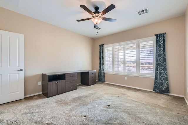 interior space featuring ceiling fan, baseboards, visible vents, and light carpet