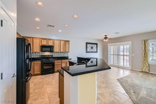 7567 Wingspread St, North Las Vegas, NV 89084 - kitchen with black appliances, tasteful backsplash, a ceiling fan, recessed lighting, and dark countertops
