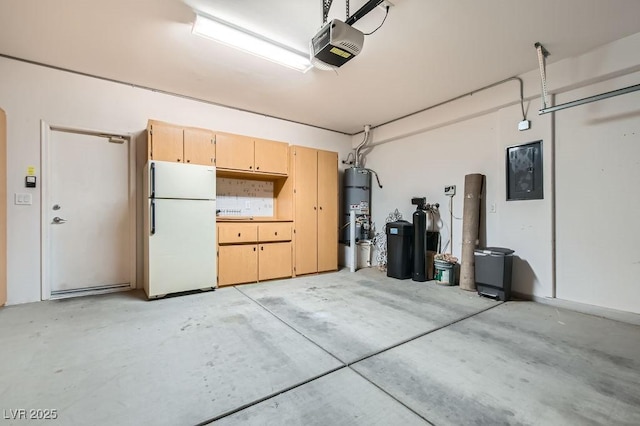 garage featuring secured water heater, electric panel, a garage door opener, and freestanding refrigerator