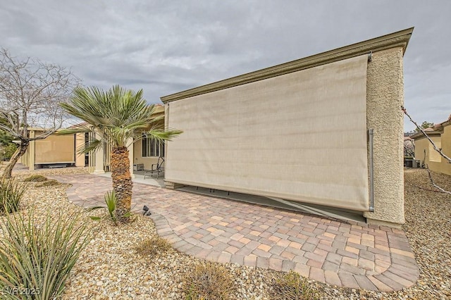 7567 Wingspread St, North Las Vegas, NV 89084 - view of side of home featuring a patio and cooling unit