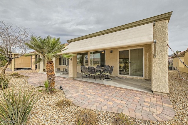7567 Wingspread St, North Las Vegas, NV 89084 - rear view of property with a patio area, stucco siding, and central air condition unit