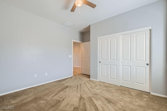 unfurnished bedroom with carpet, visible vents, a closet, and baseboards