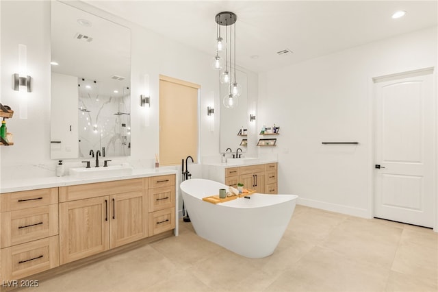 full bathroom with two vanities, visible vents, a sink, a freestanding bath, and a marble finish shower