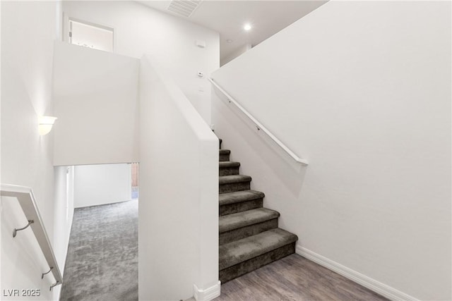 stairway featuring recessed lighting, visible vents, baseboards, and wood finished floors