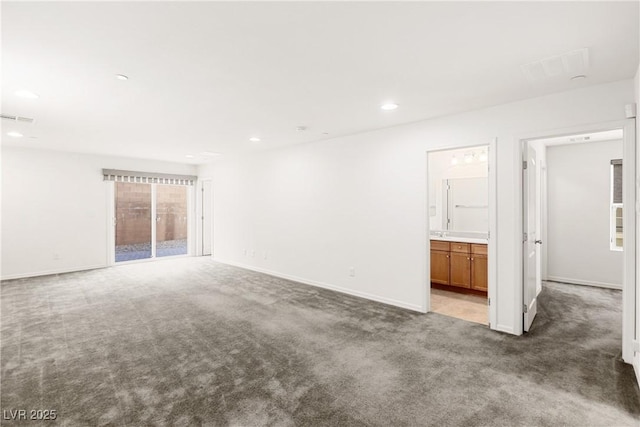 carpeted empty room with visible vents, recessed lighting, and baseboards