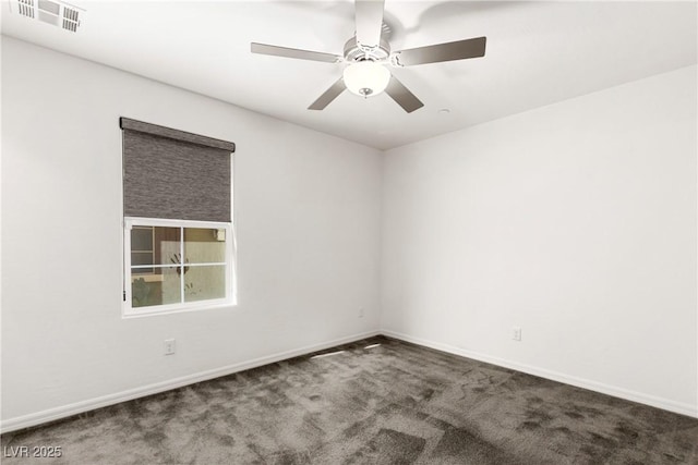 carpeted empty room featuring baseboards, visible vents, and ceiling fan