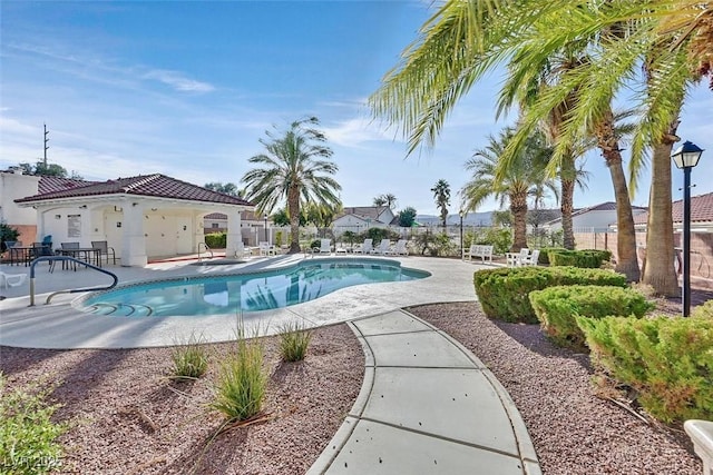 view of pool with a fenced in pool, a patio, and fence