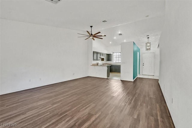 unfurnished living room featuring dark wood-style floors, ceiling fan, and visible vents