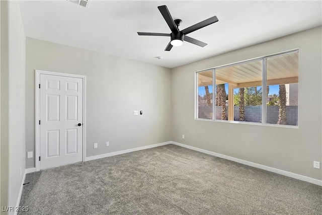 unfurnished room with carpet flooring, visible vents, a ceiling fan, and baseboards