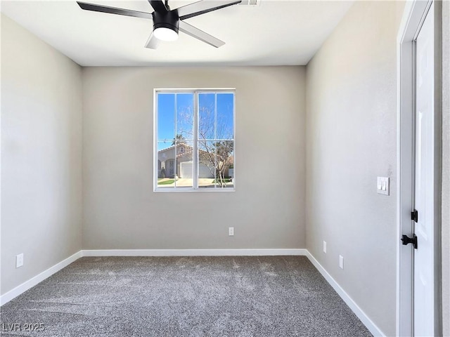 carpeted spare room with baseboards and a ceiling fan