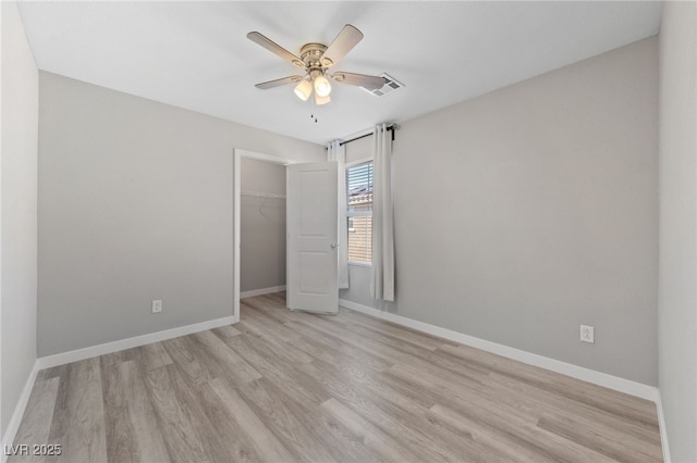 unfurnished bedroom featuring visible vents, a ceiling fan, baseboards, a closet, and light wood-type flooring