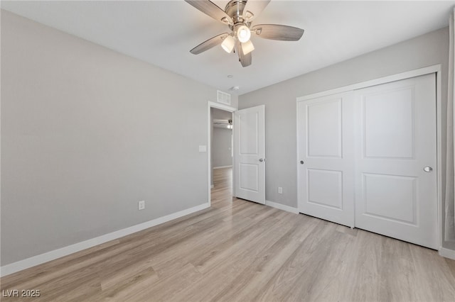 unfurnished bedroom featuring a ceiling fan, visible vents, baseboards, a closet, and light wood-type flooring