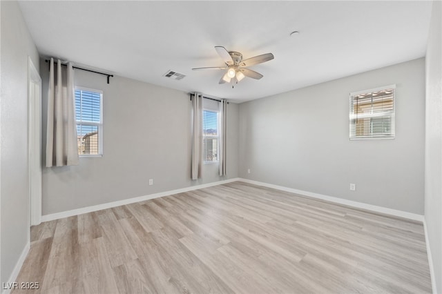 empty room with ceiling fan, visible vents, baseboards, and light wood-type flooring