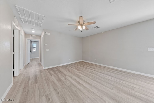 unfurnished room with ceiling fan, light wood finished floors, and visible vents