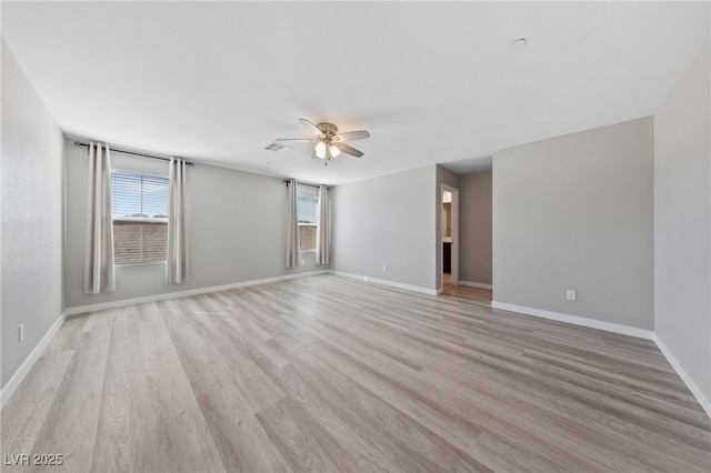 unfurnished room with ceiling fan, light wood finished floors, plenty of natural light, and baseboards