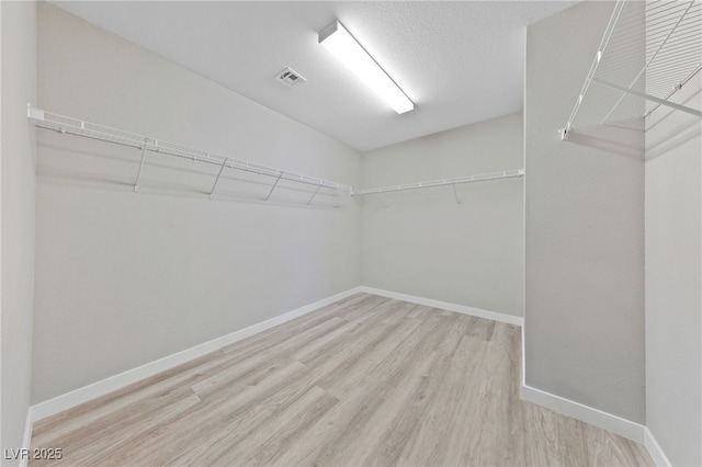 spacious closet with wood finished floors and visible vents