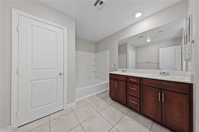 bathroom with double vanity, visible vents, a sink, and tile patterned floors