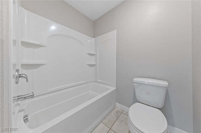 bathroom with tile patterned flooring, baseboards, tub / shower combination, and toilet