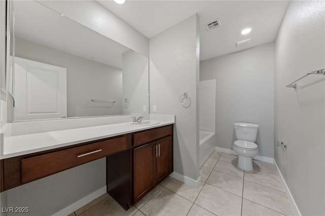 bathroom featuring toilet, vanity, baseboards, visible vents, and tile patterned floors