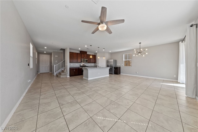 unfurnished living room featuring stairway, recessed lighting, baseboards, and ceiling fan with notable chandelier