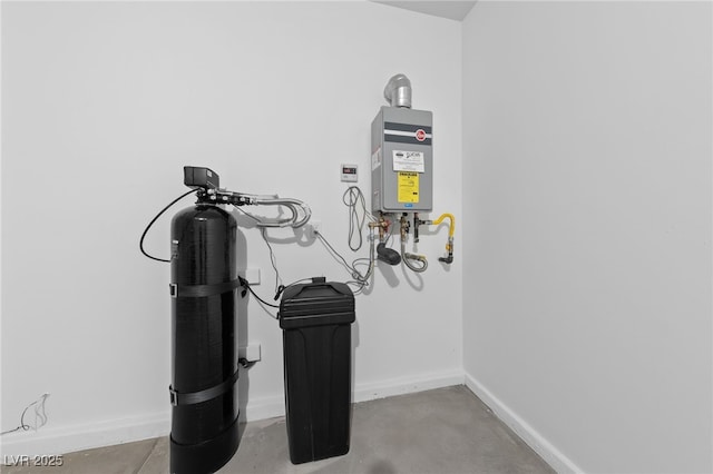 interior details featuring concrete flooring, tankless water heater, and baseboards